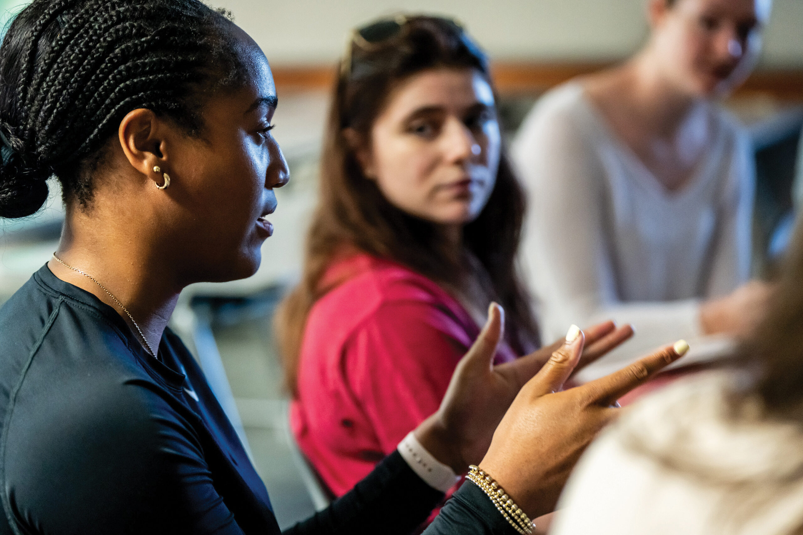 school psychology students in the midst of a conversation in a classroom